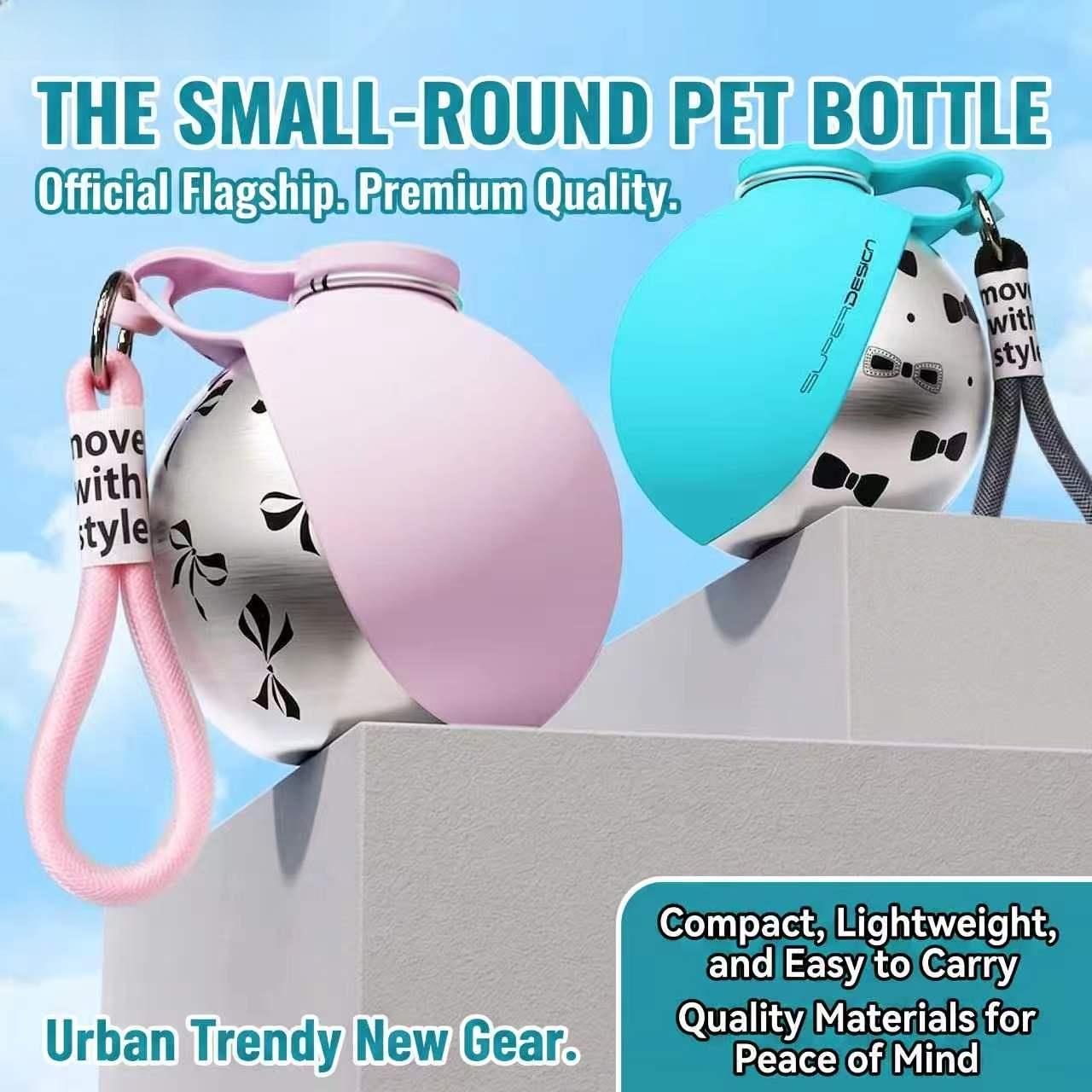 Two small pet water bottles with flip-top lids are shown on a gray pedestal against a light blue sky background. One bottle has a pink flip-top cover and a pink wrist strap, and the other has a turquoise flip-top cover and a dark gray wrist strap.
