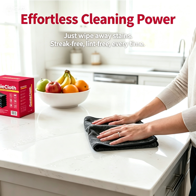 A person wipes a white kitchen countertop with a dark gray cloth. A red box of PableCloth cleaning cloth is visible on the left, with a bowl of fruit in the background.