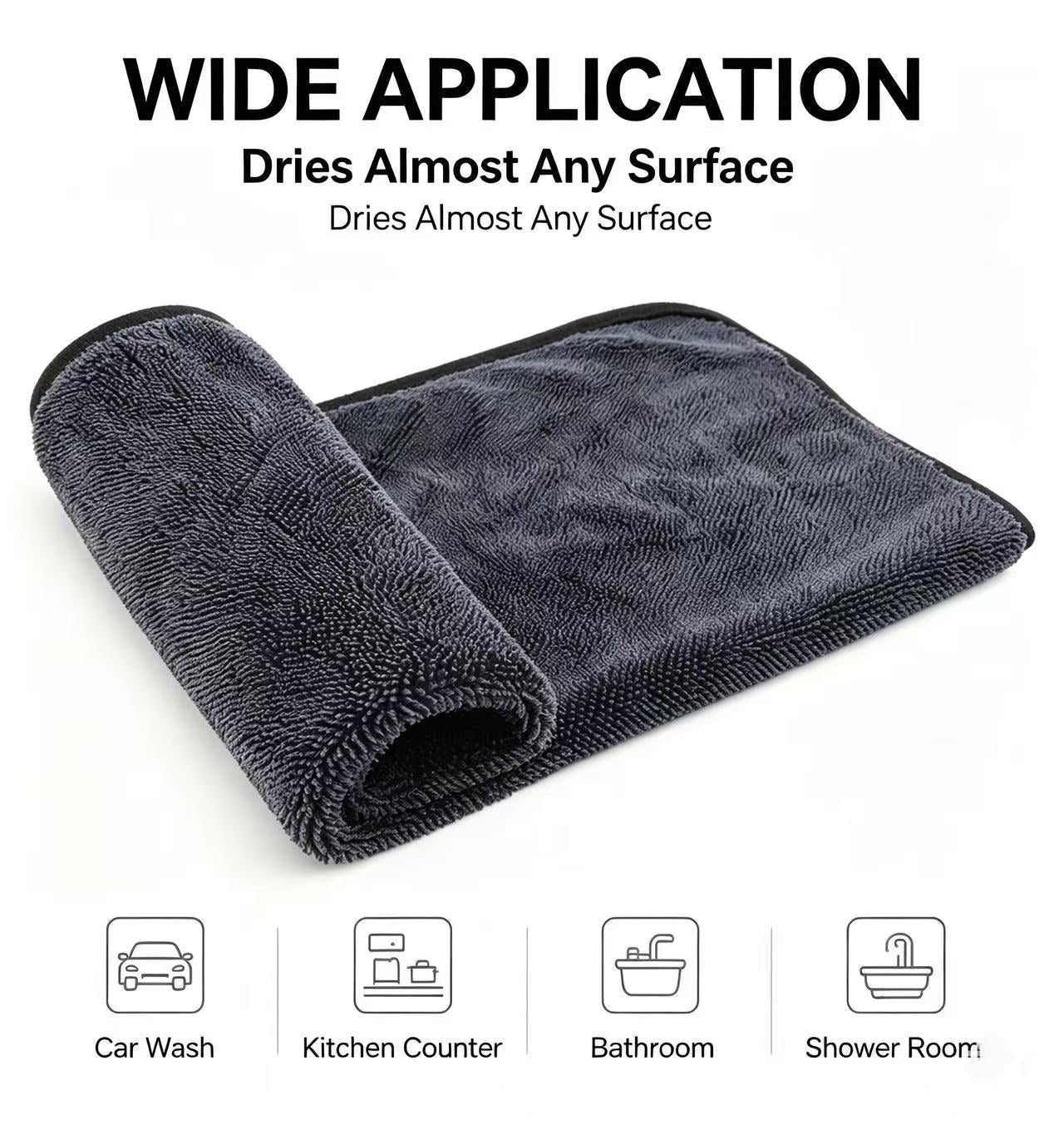 A dark gray microfiber drying towel shown rolled and partially unrolled on a white background, with text reading 'WIDE APPLICATION' and small icons for car wash, kitchen counter, bathroom, and shower room.
